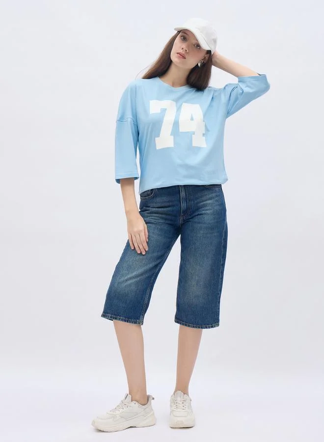 Styli Styli Women Light Blue Exaggerated Shoulder Graphic Oversized T-Shirt