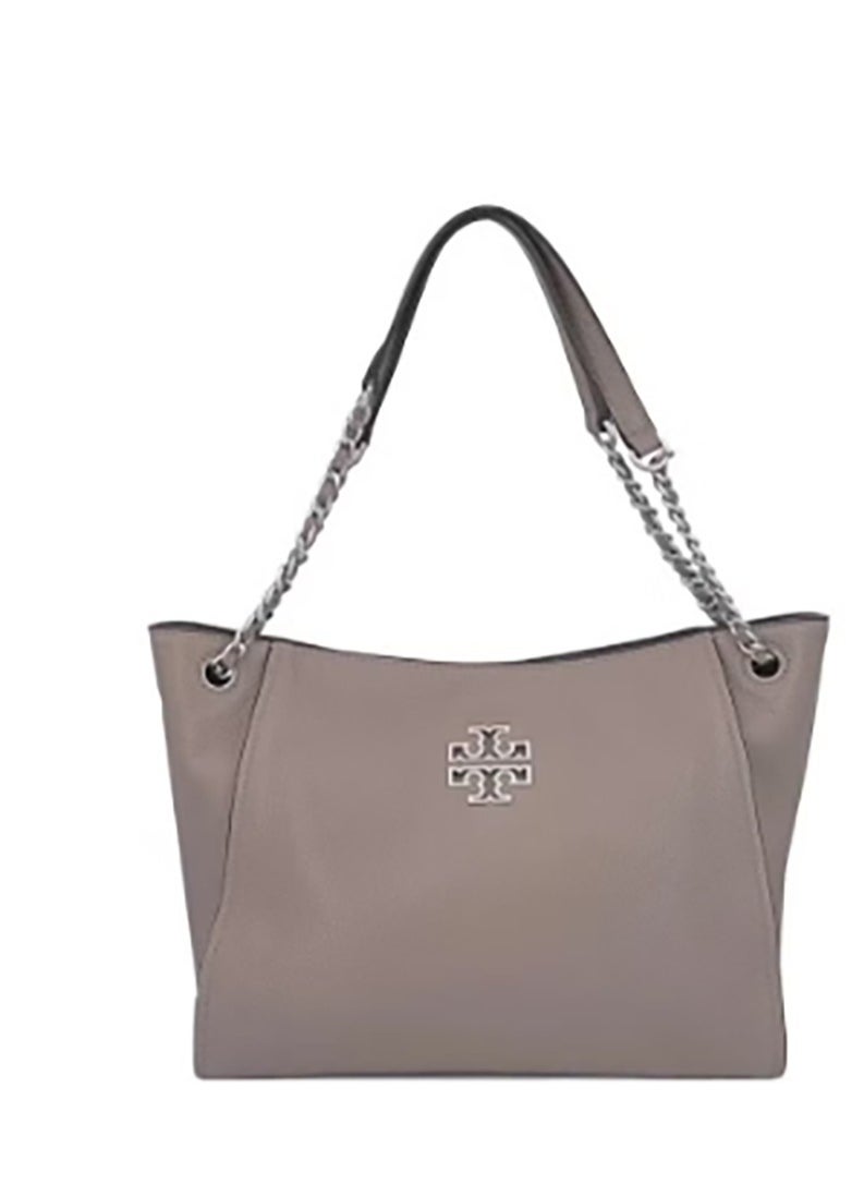 TB - The Tory Burch Britten tote, made of cowhide, features a simple yet fashionable design. With a large capacity, it's perfect for commuters and can be carried as either a handbag or a shoulder bag. - Image 1