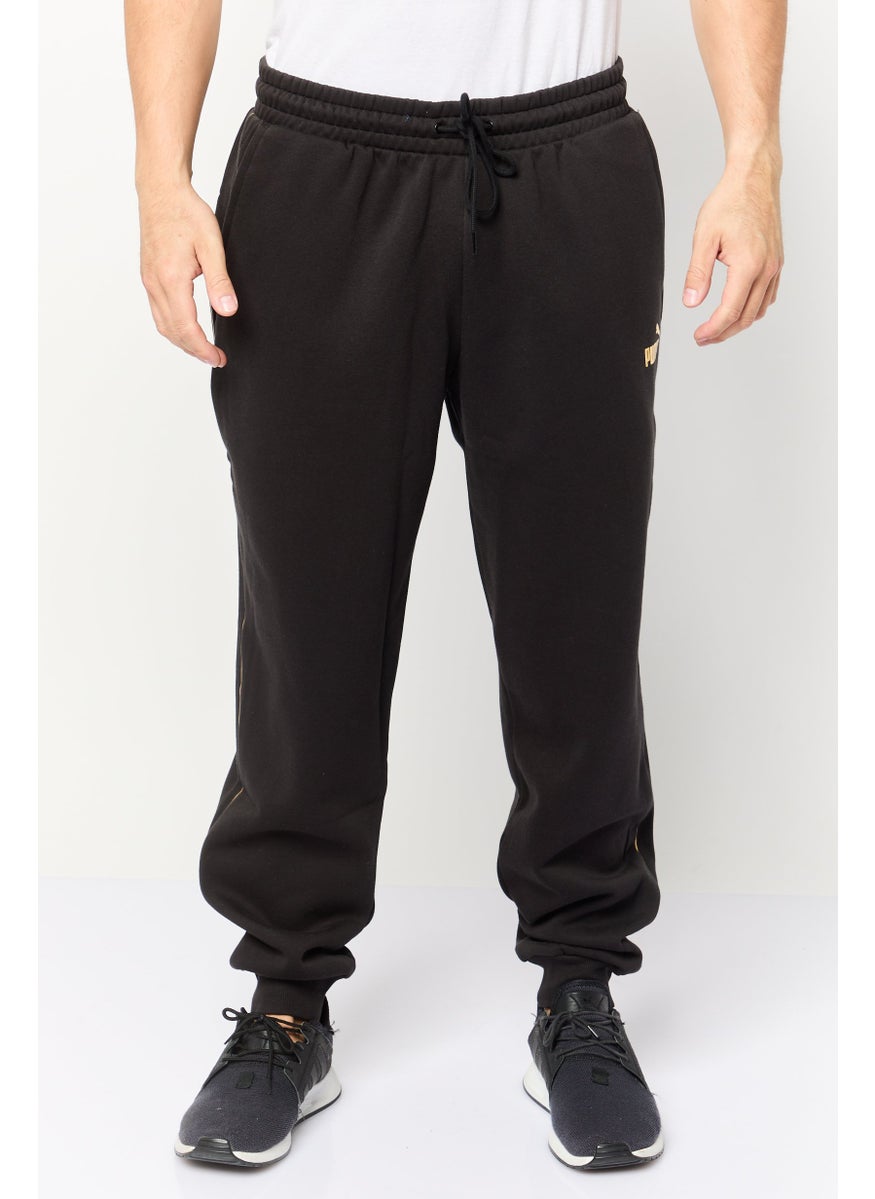 PUMA Men Sportswear Fit Brand Logo Outdoor Sweatpants, Black  - Image 1