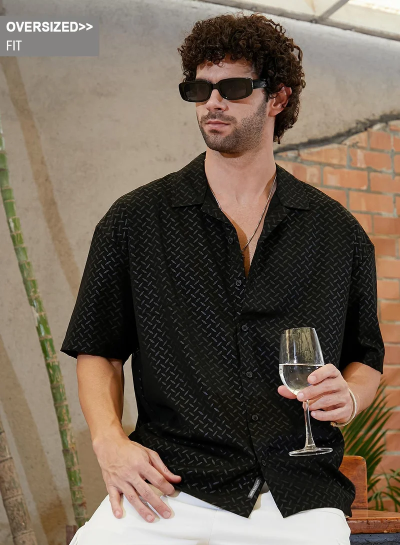 Campus Sutra Campus Sutra Men's Onyx Black Marquise-Imprint Oversized Shirt For Casual Wear | Cuban Collar | Short Regular Sleeves | Button Closure | Oversized Shirt Crafted With Comfort Fit For Everyday Wear