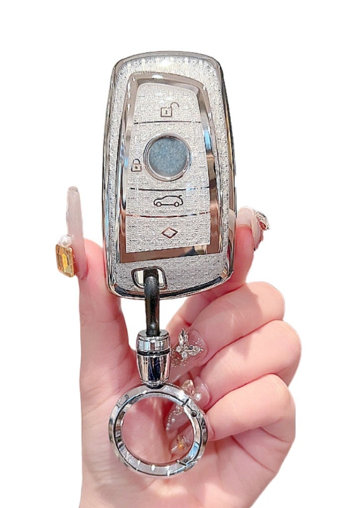 OUYoo غطاء مفتاح OUYoo لسيارات BMW، واقي مفاتيح من TPU الناعم مع سلسلة مفاتيح لامعة، متوافق مع مفاتيح BMW الذكية للموديلات: X1، X3، X4، X5، X6، 1، 2، 4، 5، 6، 7، M3، M5، M6، GT3، GT5، G30، F10، F15، F16، F20، يأتي مع سلسلة مفاتيح. (لون أبيض). - Image 1