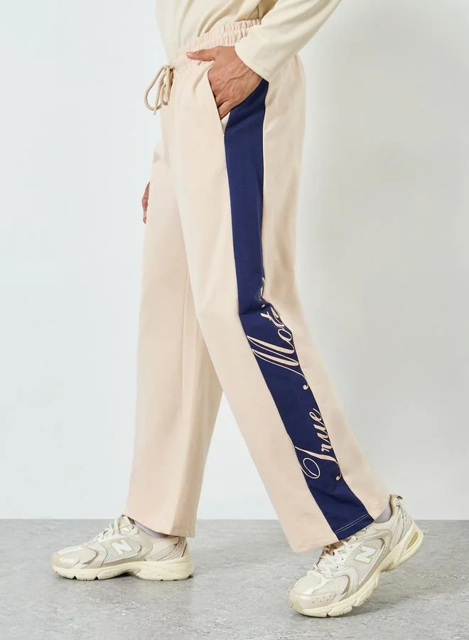 Men Beige Oversized Contrast Panel Printed Joggers