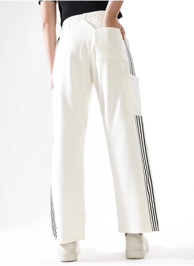 HIGH STAR Women Track Pants in Off White featuring Wide Leg fit with a solid pattern, no sleeves, regular length, secured with elasicated + drawstring closure, crafted from terry – a must-have for those who love trendy fashion.