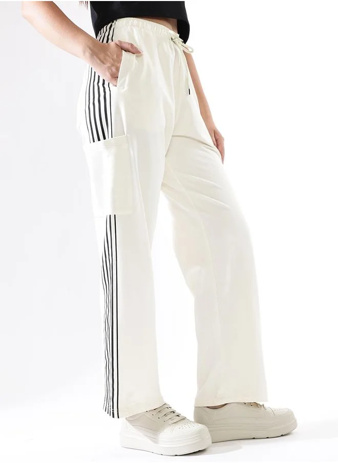 HIGH STAR Women Track Pants in Off White featuring Wide Leg fit with a solid pattern, no sleeves, regular length, secured with elasicated + drawstring closure, crafted from terry – a must-have for those who love trendy fashion.