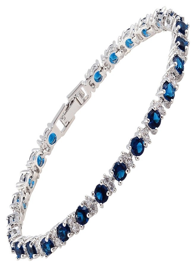 RIZILIA Round Simulated Blue Sapphire and White Cubic Zirconia 18K White gold Plated Tennis Bracelet, 7" - Image 1