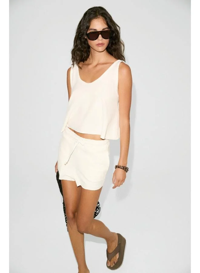 PETUNYAL Women's V-Neck Tank Top and Cord-Pocket Short Shorts in Ecru Top-and-Bottom Set.