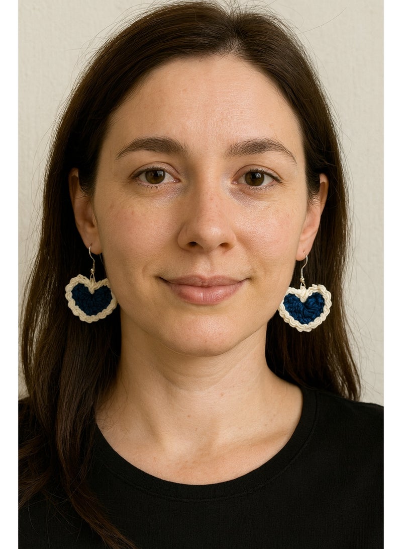 Lolly Handmade Crochet Heart Earrings – These stunning earrings feature a heart design crafted with dark blue and white yarn. The contrasting colors give them a striking look, making them perfect for adding a touch of charm to any outfit. Whether you're dressing up for a special occasion or looking for a cute everyday accessory, these earrings will make a statement. - Image 1