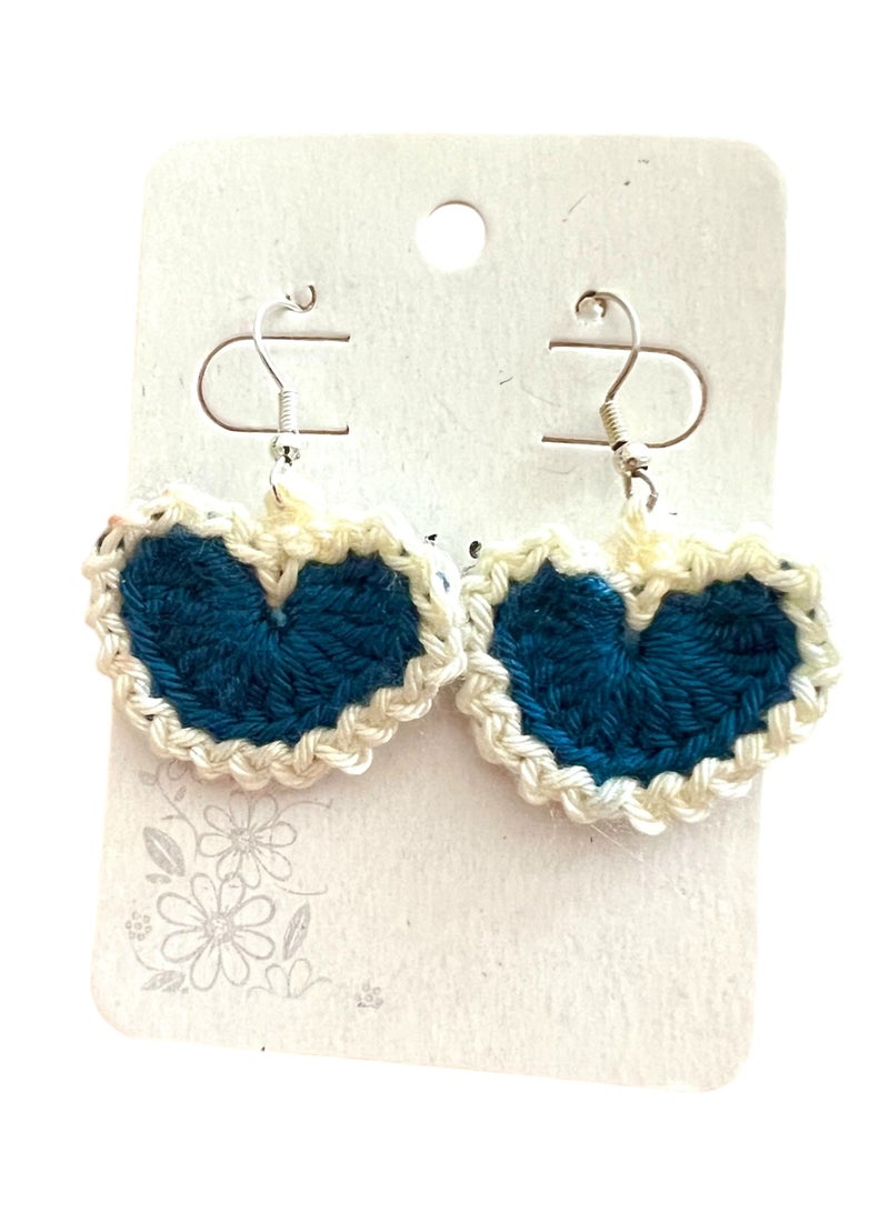 Lolly Handmade Crochet Heart Earrings – These stunning earrings feature a heart design crafted with dark blue and white yarn. The contrasting colors give them a striking look, making them perfect for adding a touch of charm to any outfit. Whether you're dressing up for a special occasion or looking for a cute everyday accessory, these earrings will make a statement. - Image 2
