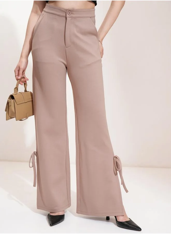 Tokyo Talkies Mid Rise Flared Trousers with Bow Tie Detail