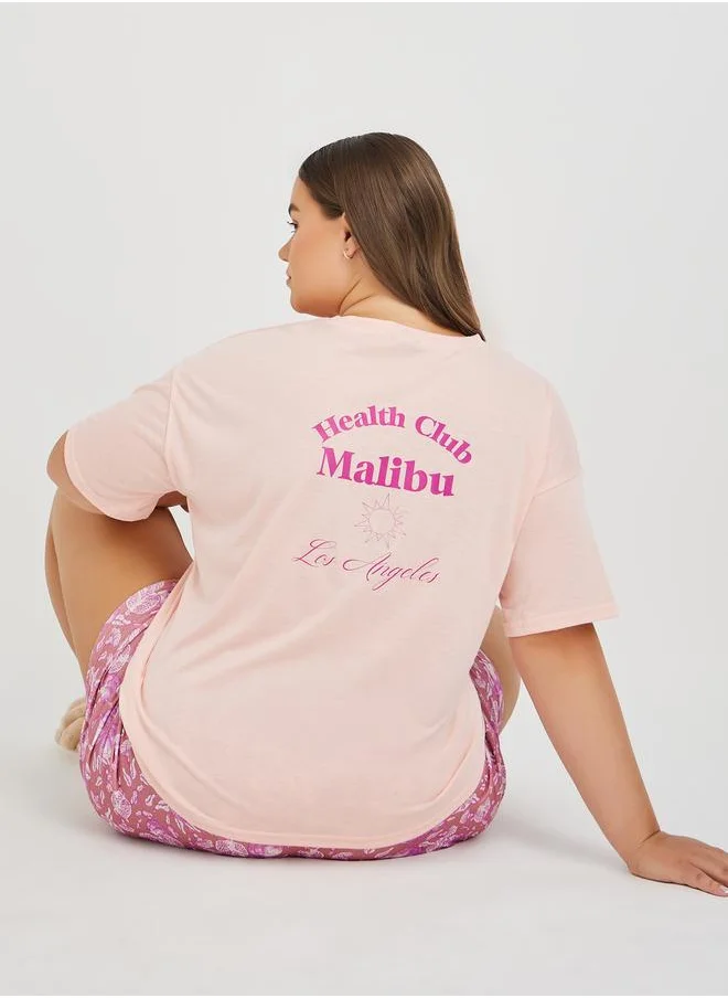 Styli Styli Plus Size Back Graphic Print T-Shirt and All-Over Fruit Print Shorts Set