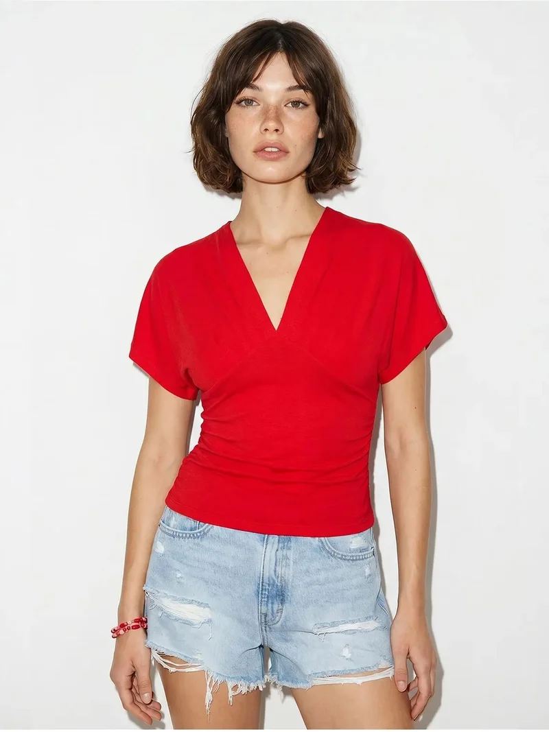 بيانكو لوتشي LUCCI Slim Fit V-Neck Jersey Blouse