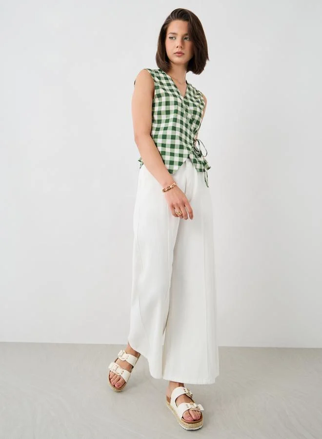 تايك تو توب لف بنقشة كاروهات بدون أكمام مع تفاصيل ربط