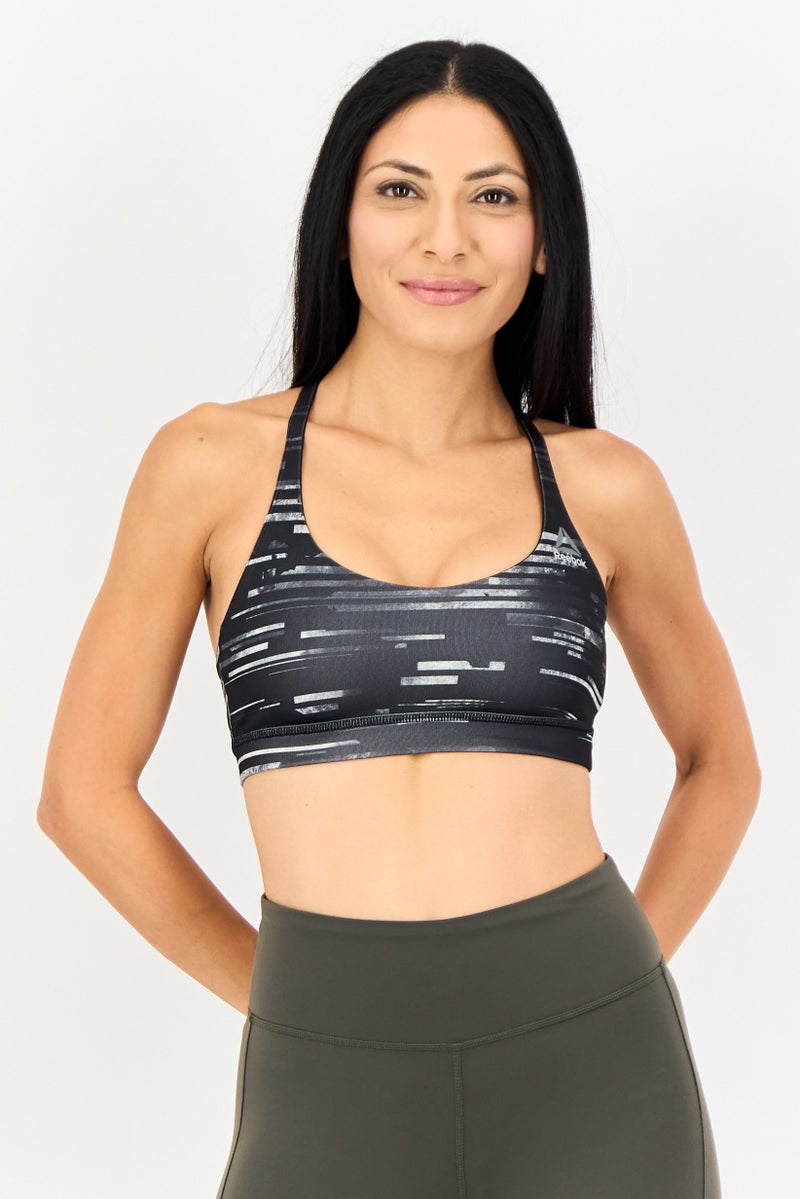 Reebok سوتيان رياضي غير مبطن للنساء بطبعة شاملة، متعدد الألوان - Image 1