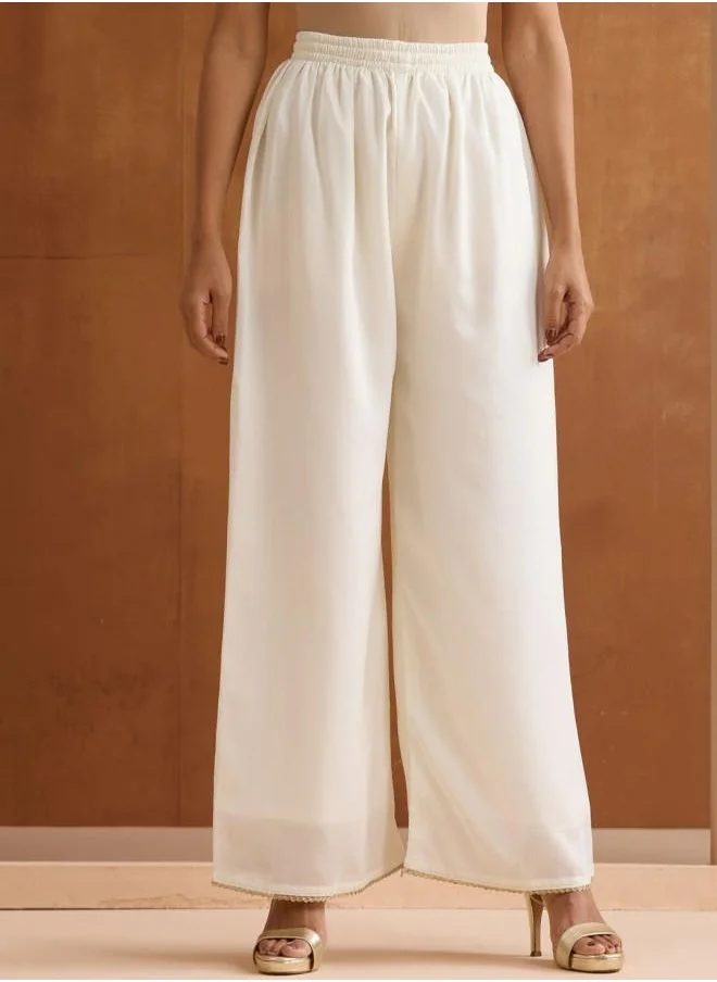 آي شين Mid Rise Women Off White Rayon Kurta Set with Embroidered pattern Tunic and Palazzo features a Round neckline and Three-Fourth Sleeve secured with Elastic closure and styled in Straight Fit ideal for Festive moments — exude elegance in every glance.