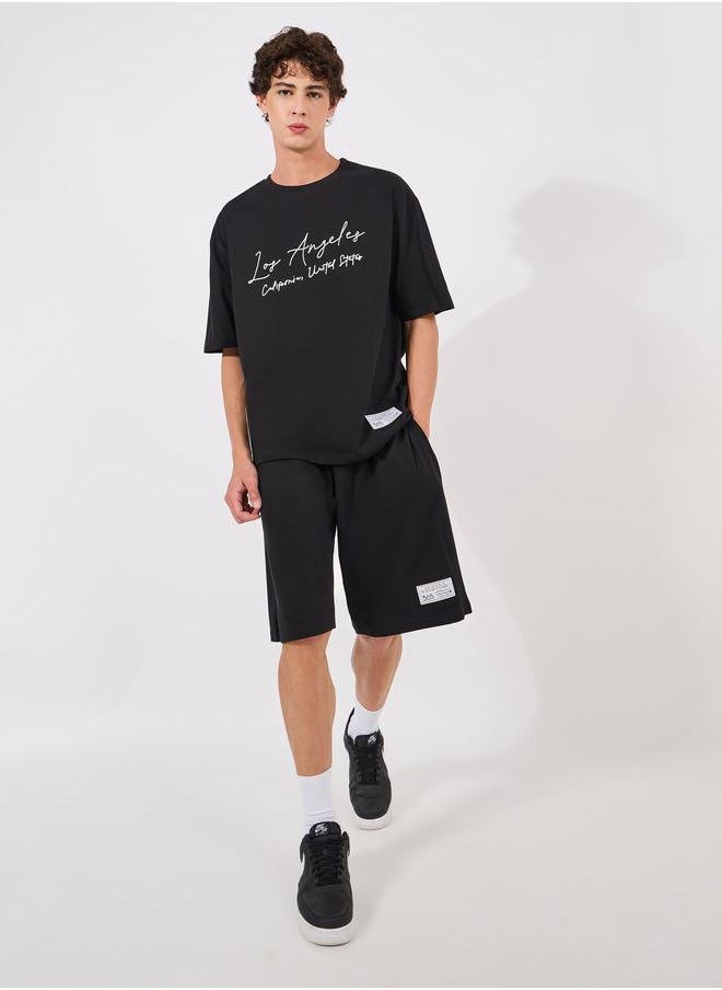 Styli Styli Chest Print Heavy Cotton Jersey T-Shirt and Badge Detail shorts Co-Ords  - Image 1
