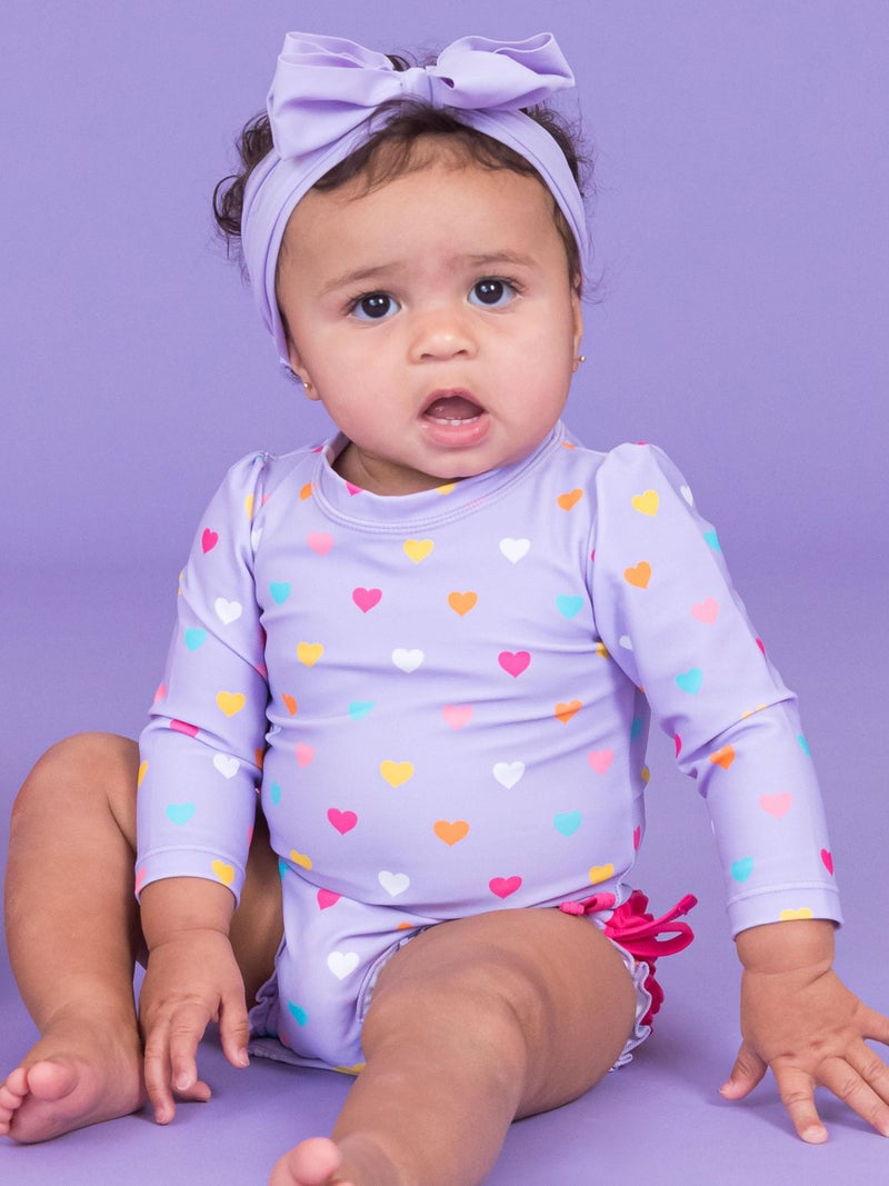 RuffleButts Baby Girls UPF 50+ Sun Protection Polka Dot Long Sleeve One Piece Rash Guard Swimsuit with Zipper - Lavender Colorful Hearts, 6-12m - Image 2