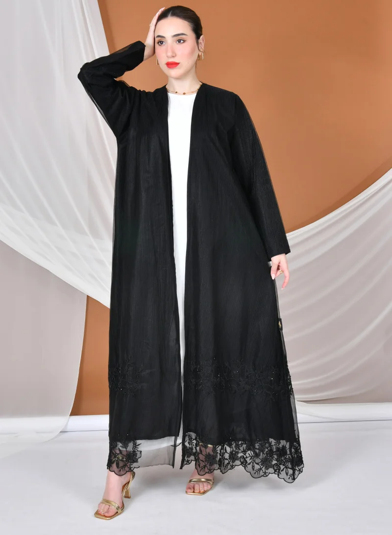 HAWRAA ABAYA A black, quarter-circle wrap abaya made of organza fabric with elegant and sophisticated embroidery at the bottom of the abaya.
