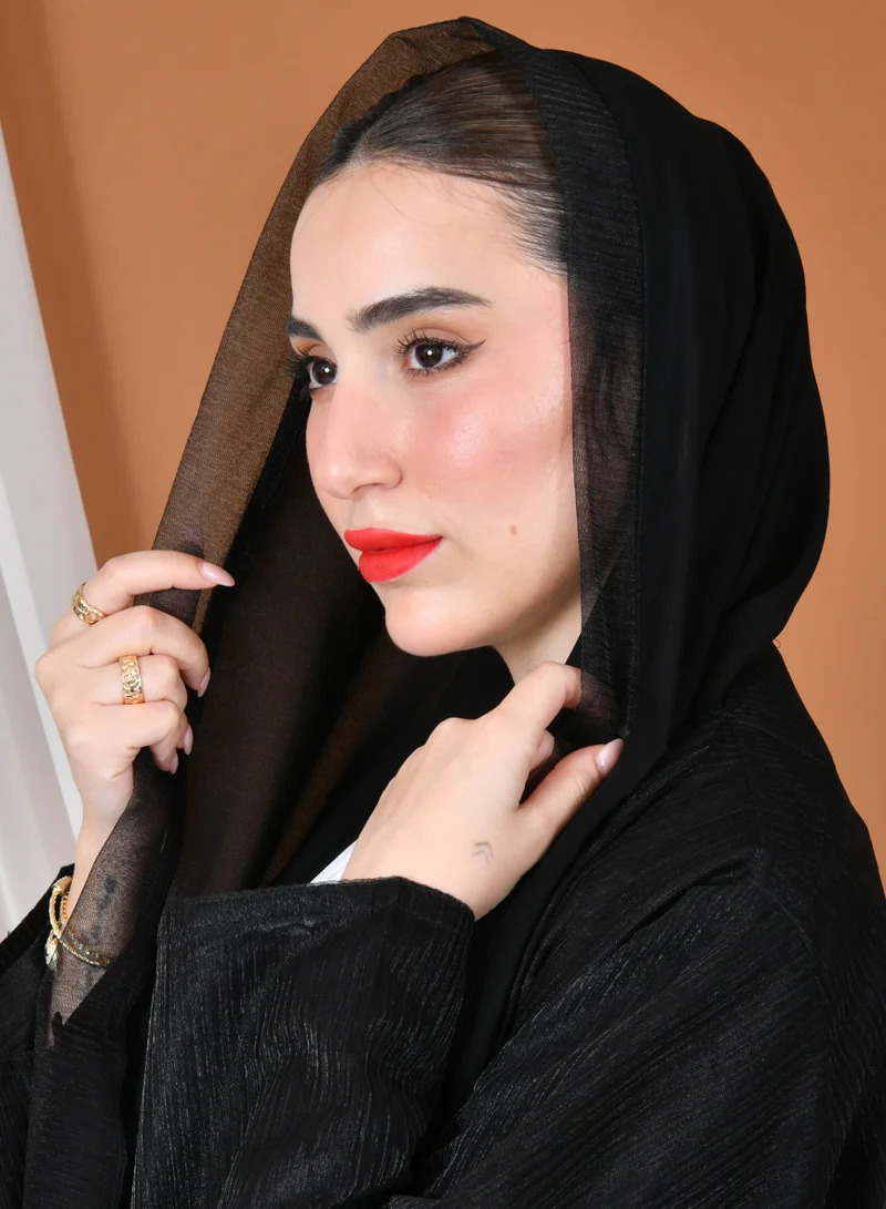 HAWRAA ABAYA A black, quarter-circle wrap abaya made of organza fabric with elegant and sophisticated embroidery at the bottom of the abaya.