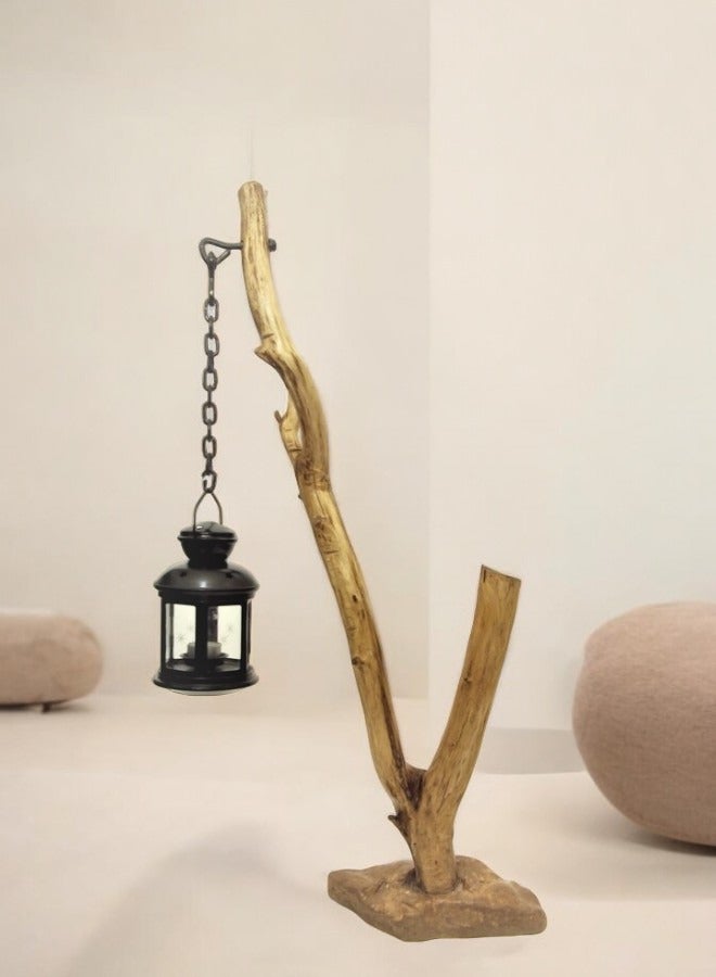 Black metal lantern fixed with a metal chain on a natural tree trunk  - Image 1