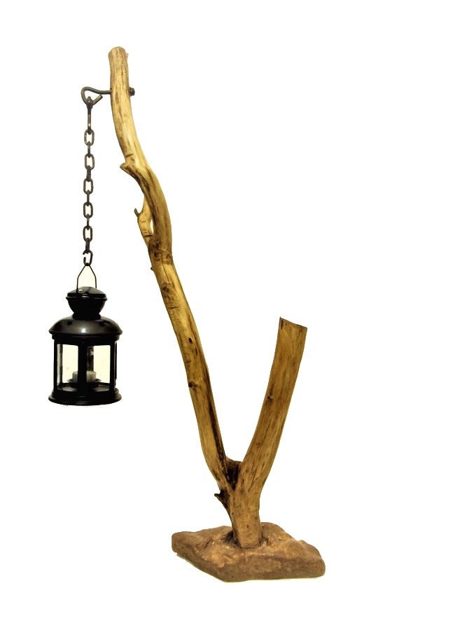 Black metal lantern fixed with a metal chain on a natural tree trunk  - Image 2
