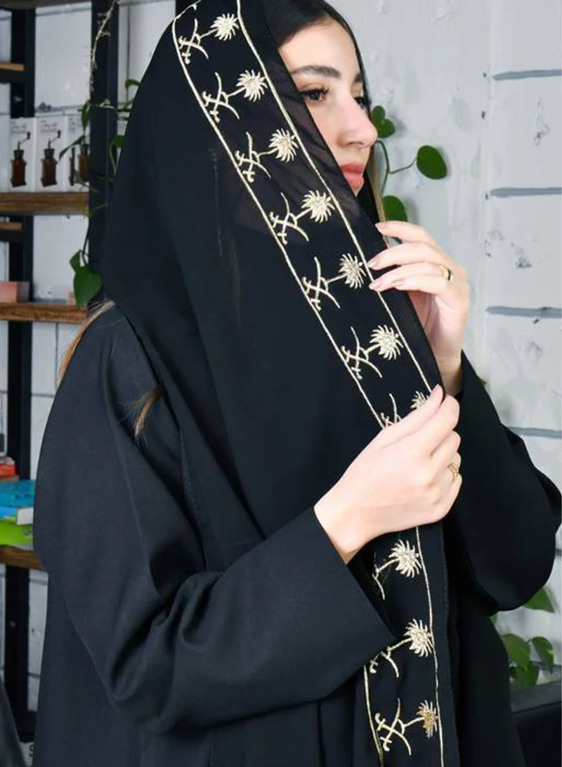 HAWRAA ABAYA Black silk shawl with gold embroidery of the Kingdom's emblem extending along the edges, Saudi National Day design
