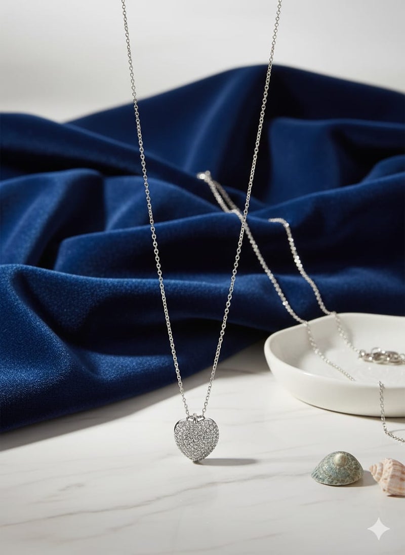 A fully covered, prominent heart-shaped necklace with sparkly, glittery detailing - on a delicate silver-plated chain - with additional links for adjusting the size. - Image 5