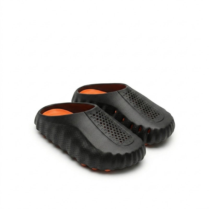 A sleek and comfortable closed-toe slide sandal designed with a unique wave-textured side profile and top ventilation holes, ensuring maximum breathability and cushioned comfort for daily wear.