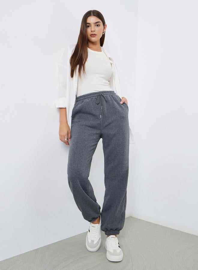 Styli Women Grey Solid Wide Leg Joggers with Drawstring Waist - Image 1