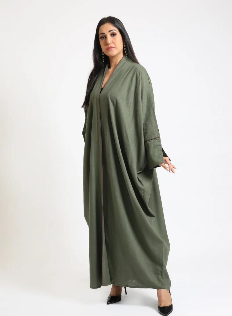 Nikias Olive green linen abaya with Bahraini cut and burgundy pipping on sleeves and front