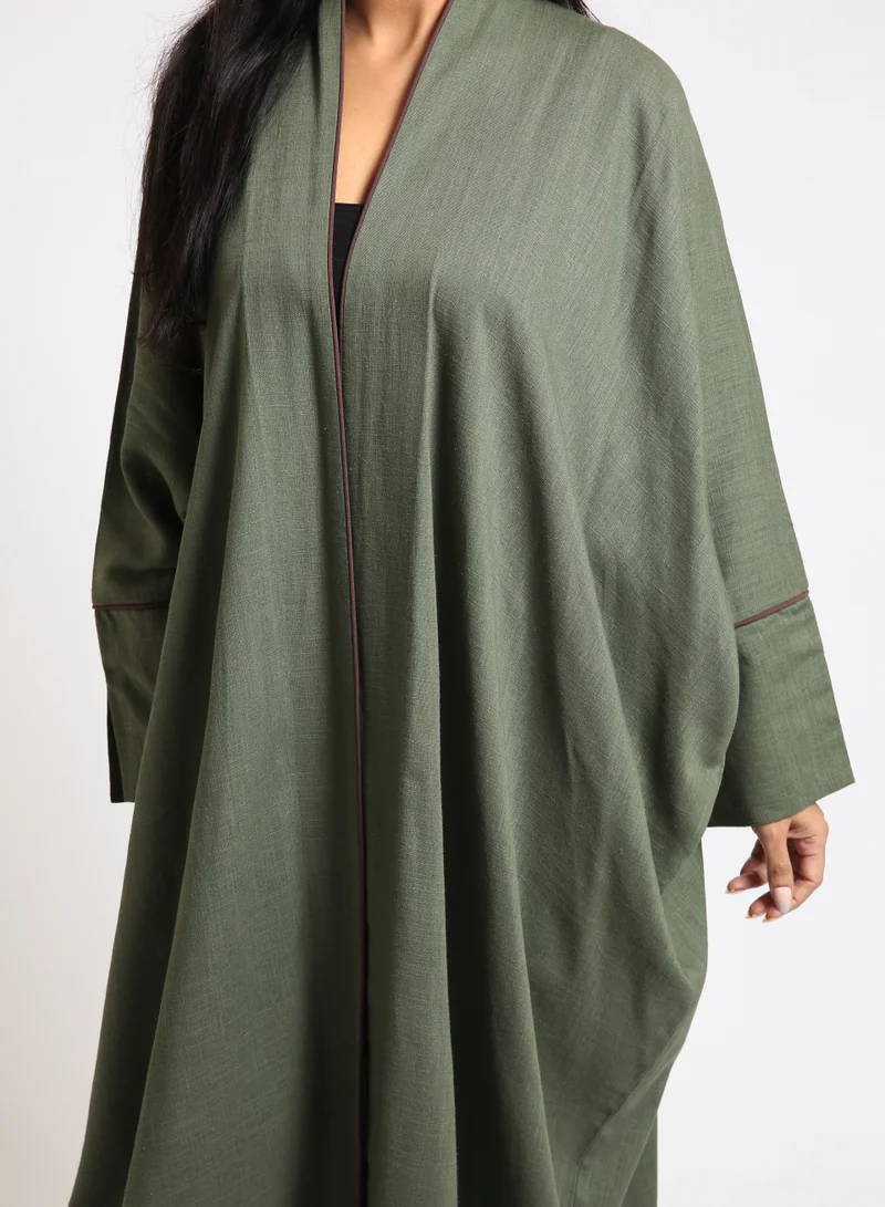 Nikias Olive green linen abaya with Bahraini cut and burgundy pipping on sleeves and front