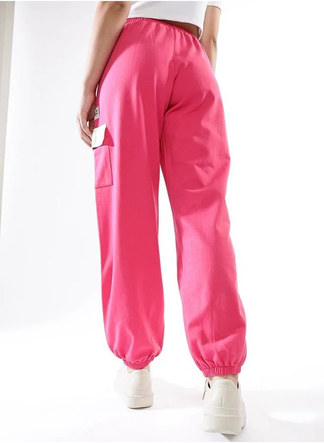Hubberholme Women Track Pants in Pink featuring Jogger fit with a printed pattern, no sleeves, regular length, secured with elasicated + drawstring closure, crafted from terry – your go-to choice for effortless elegance.