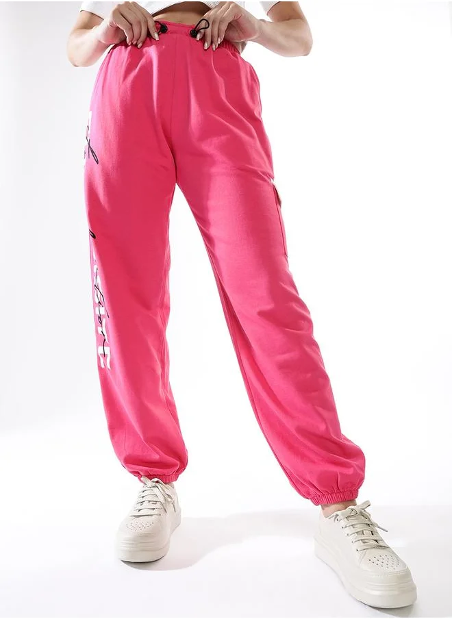 Hubberholme Women Track Pants in Pink featuring Jogger fit with a printed pattern, no sleeves, regular length, secured with elasicated + drawstring closure, crafted from terry – your go-to choice for effortless elegance.