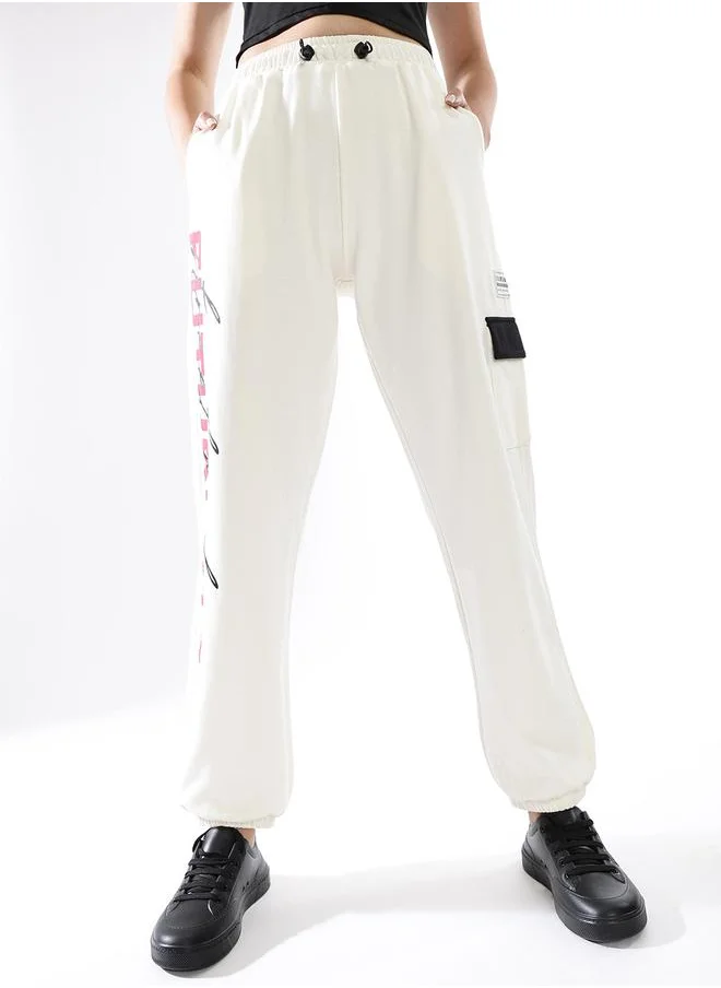 هوبرهولمي Women Track Pants in Off White featuring Jogger fit with a printed pattern, no sleeves, regular length, secured with elasicated + drawstring closure, crafted from terry – a trendsetting piece that blends fashion and comfort.