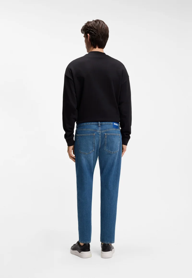 هوجو جينز بقصة مستدقة من دينم مطاطي أزرق متوسط