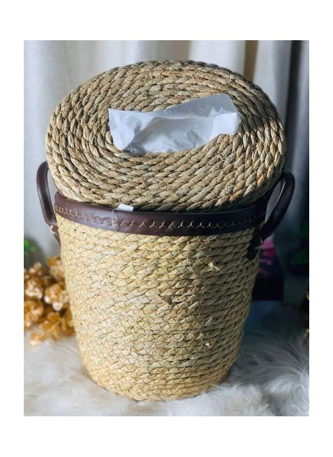 A trash can and a wicker tissue box