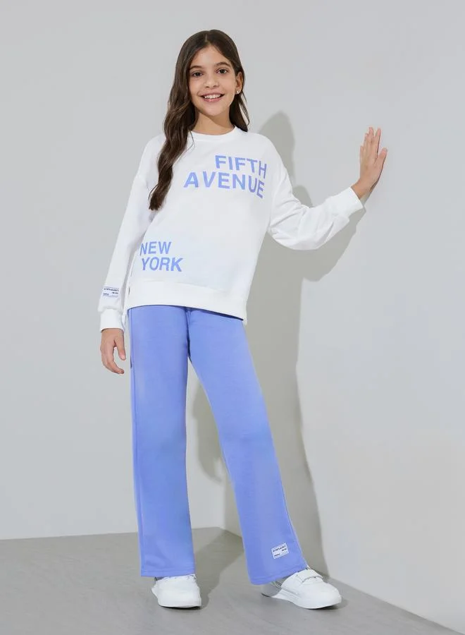 Styli Teen Girls Off White Graphic Print Sweatshirt and Blue Straight Leg Pants Set