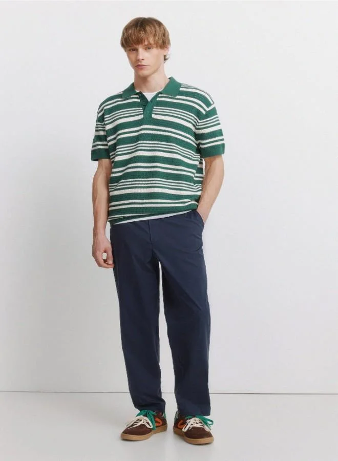 Trousers made from a lightweight cotton and nylon blend fabric with stretch, providing comfort. They feature an elasticated waistband on both sides for enhanced comfort, and an inner drawstring for a perfect fit. Back welt pockets with button. Relax fit.