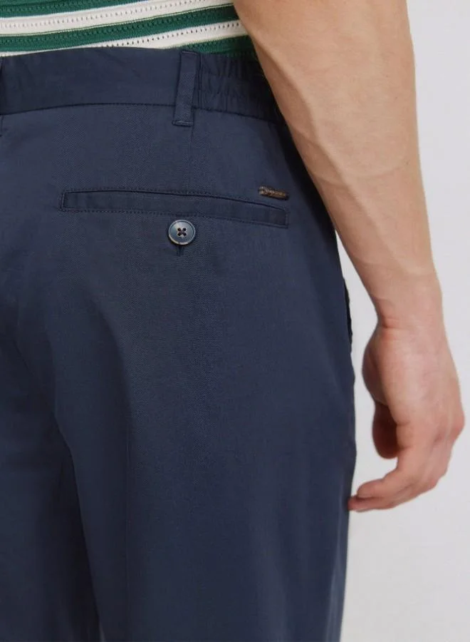 Springfield  Trousers made from a lightweight cotton and nylon blend fabric with stretch, providing comfort. They feature an elasticated waistband on both sides for enhanced comfort, and an inner drawstring for a perfect fit. Back welt pockets with button. Relax fit. for Men | Best Price UAE