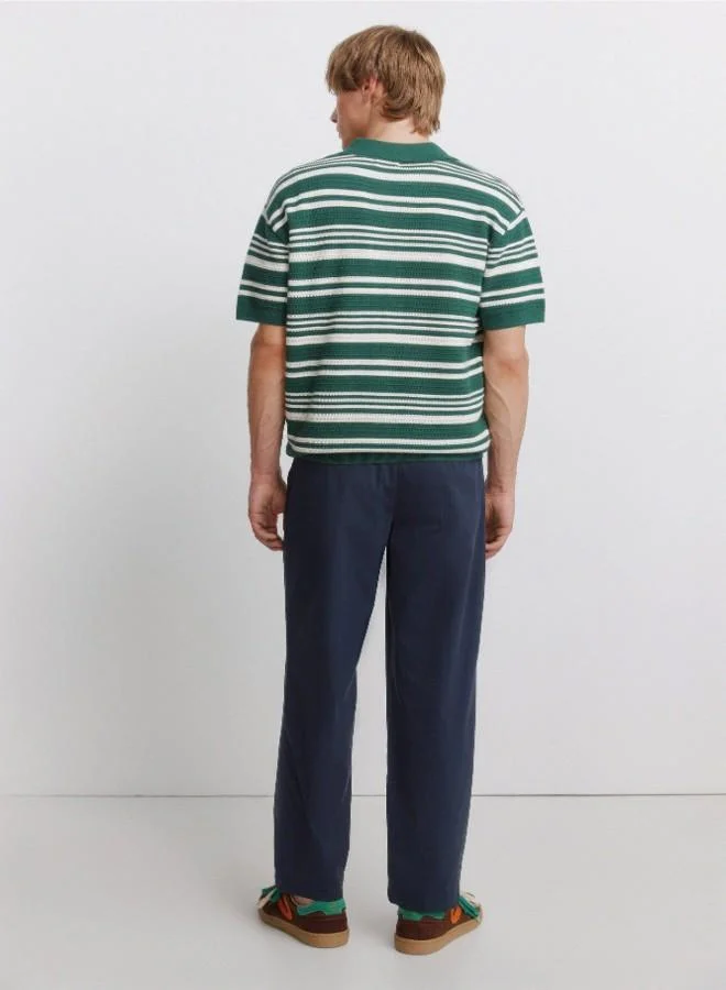 Springfield  Trousers made from a lightweight cotton and nylon blend fabric with stretch, providing comfort. They feature an elasticated waistband on both sides for enhanced comfort, and an inner drawstring for a perfect fit. Back welt pockets with button. Relax fit. for Men | Best Price UAE