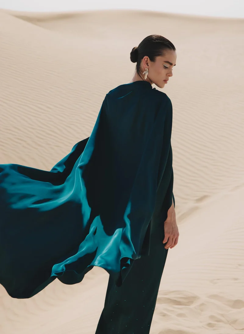 Lichi  Maxi dress with asymmetrical cape and rhinestones on the skirt for Women | Best Price UAE