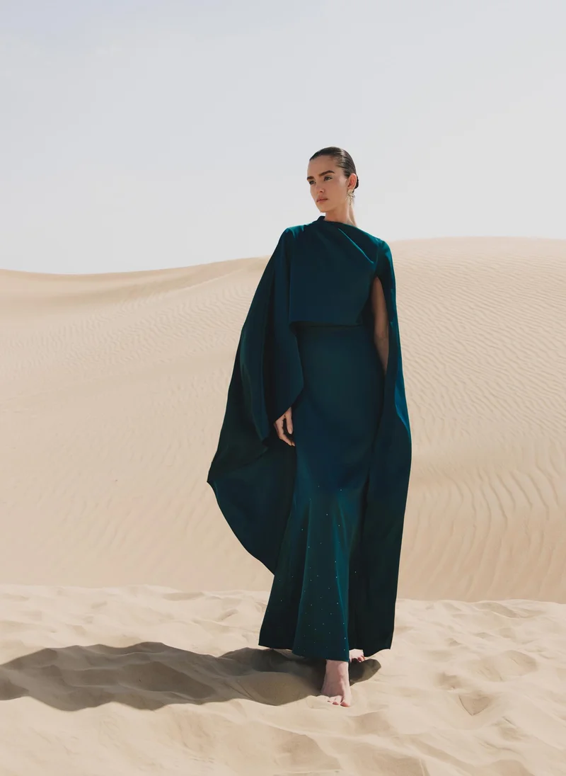 Lichi  Maxi dress with asymmetrical cape and rhinestones on the skirt for Women | Best Price UAE