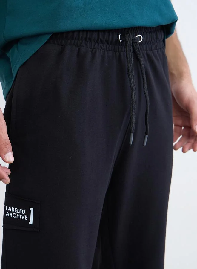 Styli Black Men Applique Patch Detail Oversized Joggers for Men | Best Price UAE