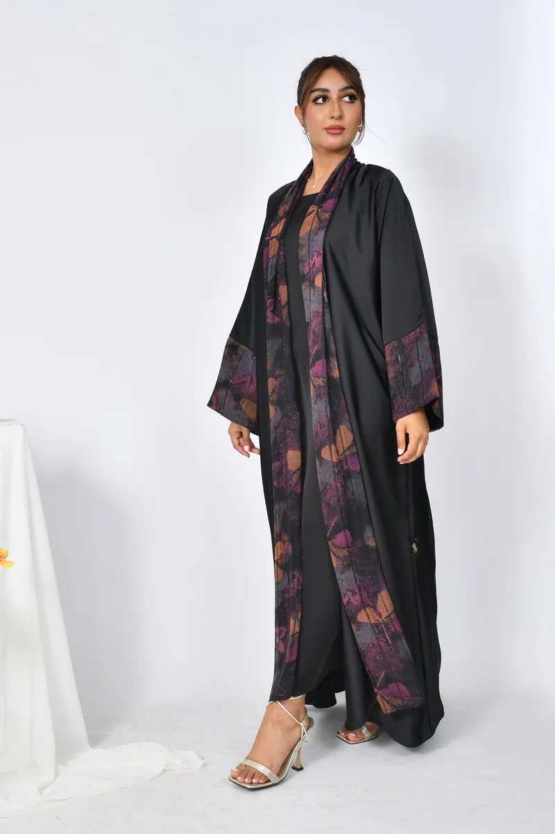 HAWRAA ABAYA A black, quarter-cloche abaya made of soft summer fabric with chiffon overlays on the sleeves and sides of the abaya.