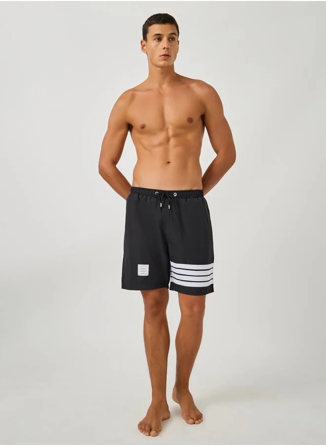 ستايلي Styli Striped Regular Fit Swim Shorts with Badge Detail