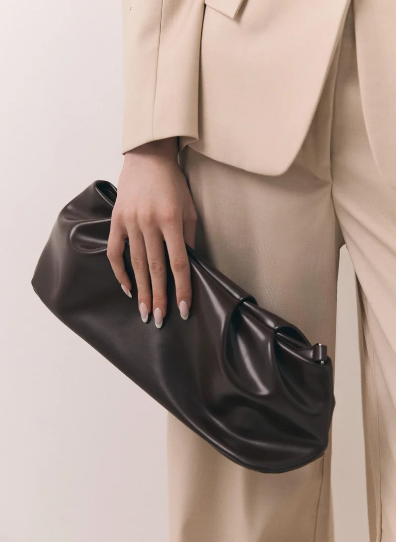 Lichi Voluminous eco-leather clutch bag with a thin strap