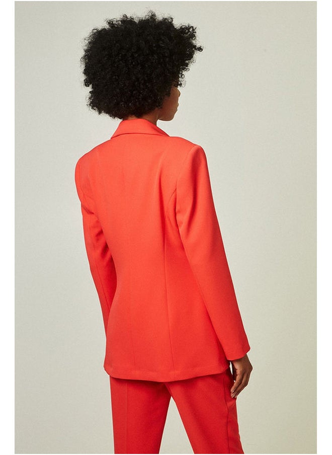 Tailored blazer with bejeweled button