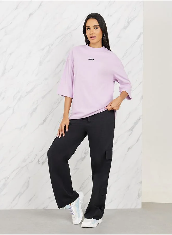 Styli Oversized Patch Detail High Neck Longline T-Shirt with 3/4 Sleeves