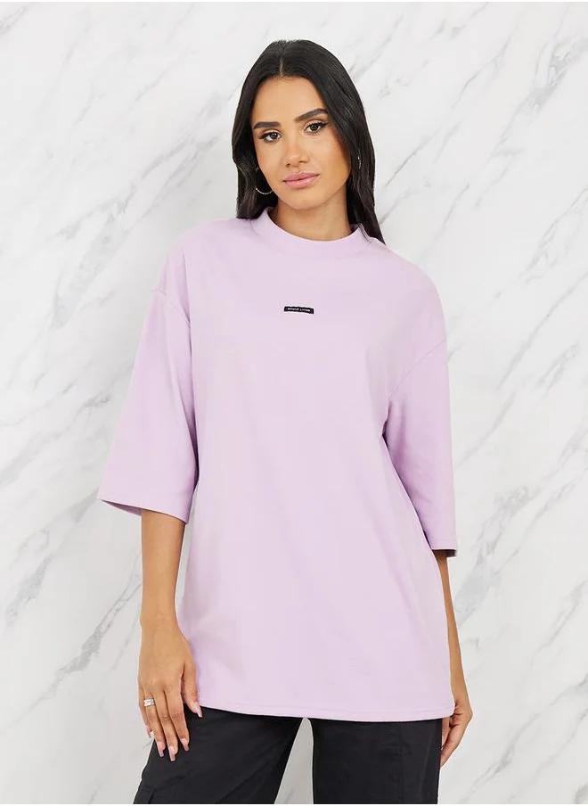Styli Oversized Patch Detail High Neck Longline T-Shirt with 3/4 Sleeves