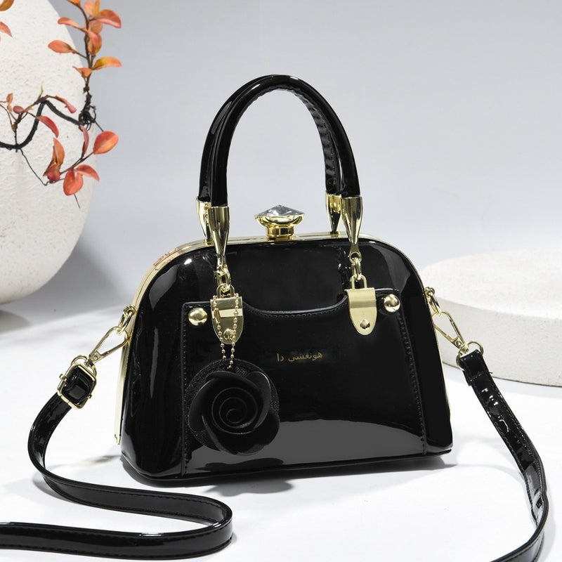 Steel armor mini shell bag, suitable for casual fashion, shiny surface, equipped with floral charm pendant, multi-functional handbag or cross-body bag, fashionable classic, lightweight and durable design - Image 1