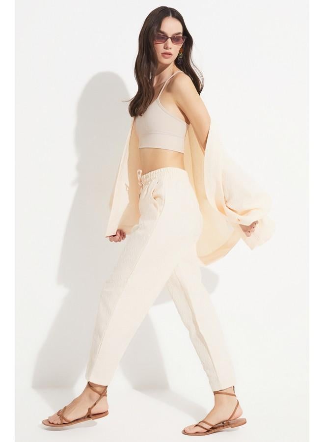 جون بنطلون نسائي بخصر مطاطي مرتفع بنقش ذاتي بيج فاتح - Image 1